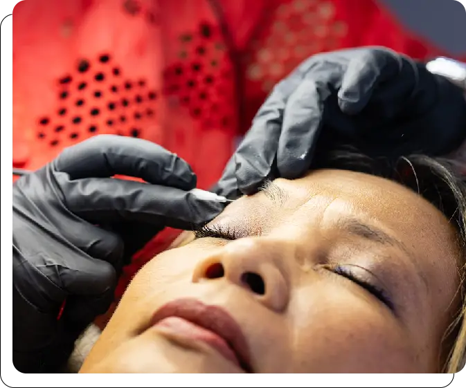 A woman getting her eyebrows waxed at the salon.